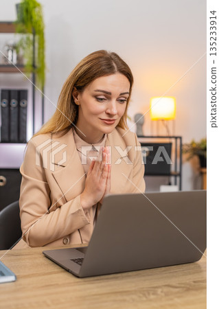 Businesswoman folds hands in prayer laptop looks up hopes for client order or project approval big Businesswoman folds hands in prayer laptop looks up hopes for client order or project approval big 135233914