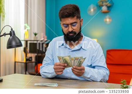 Indian man count dollars money cash banknotes feel wealthy salary profit extra winnings game jackpot Indian man count dollars money cash banknotes feel wealthy salary profit extra winnings game jackpot 135233930