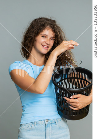 Woman dramatically taking off glasses throwing trash humorous funny rejecting disappointed gesture Woman dramatically taking off glasses throwing trash humorous funny rejecting disappointed gesture 135233956