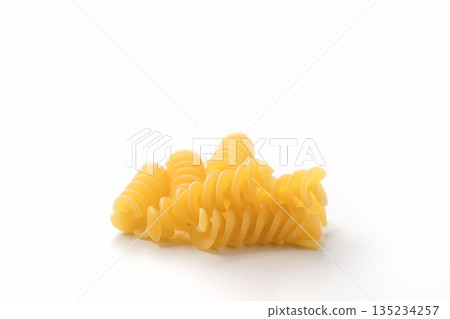 Italian dry fusilli pasta over white background with shadow Italian dry fusilli pasta over white background with shadow 135234257