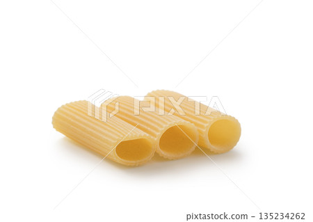 Italian dry rigatoni pasta over white background with shadow Italian dry rigatoni pasta over white background with shadow 135234262