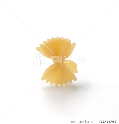 Italian dry farfalle pasta over white background with shadow top view 135234263