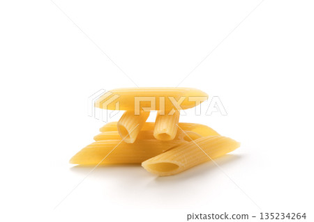 Italian dry penne rigate pasta over white background with shadow Italian dry penne rigate pasta over white background with shadow 135234264