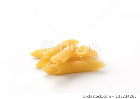 Italian dry penne rigate pasta over white background with shadow 135234265