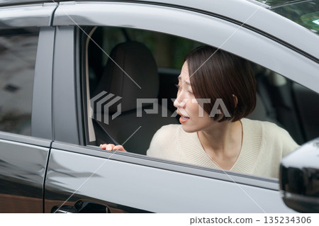 A woman driving a car 135234306