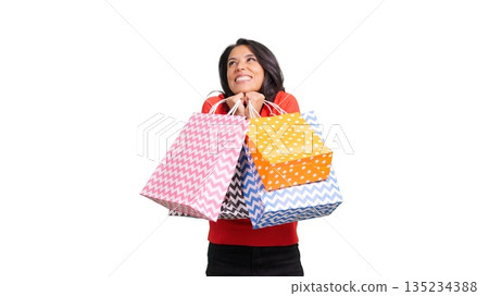 Happy woman holding shopping bags celebrating retail therapy Happy woman holding shopping bags celebrating retail therapy 135234388
