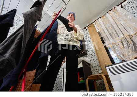 While hanging laundry after washing woman could not find one sock from pair. 135234395