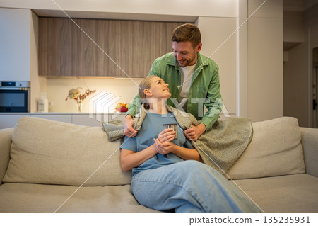 Care and love in modern relationships, man and woman partners spending time together at home. Care and love in modern relationships, man and woman partners spending time together at home. 135235931