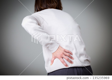 Middle women suffering from low back pain 135235969