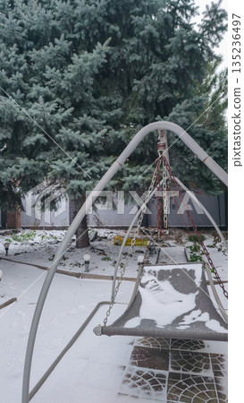A large spruce tree grows in the yard View of a snow-covered area Winter weather A large spruce tree grows in the yard View of a snow-covered area Winter weather 135236497