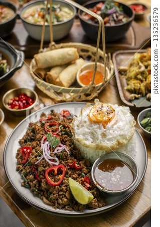 Pad Kra Pao Pork and Holy Basil Stir fry traditional thai food meal on table at restaurant in phuket thailand 135236579