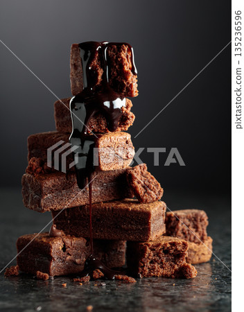 Brownie pieces on a black background. Brownie pieces on a black background. 135236596