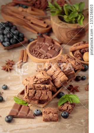Brownie with fresh blueberries and mint. 135236603