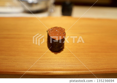 A high-end sushi restaurant serving gunkan rolls of fresh, jewel-like new salmon roe 135236694