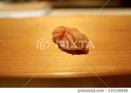 A classic Edomae sushi dish: vibrant ark shell nigiri, prepared by a skilled craftsman A classic Edomae sushi dish: vibrant ark shell nigiri, prepared by a skilled craftsman 135236696