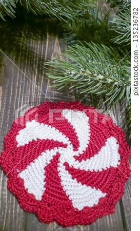Handcrafted colorful candy-shaped potholders on a wooden background. Food stand. Handcrafted colorful candy-shaped potholders on a wooden background. Food stand. 135236782