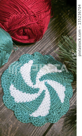 Handcrafted colorful candy-shaped potholders on a wooden background. Food stand. Handcrafted colorful candy-shaped potholders on a wooden background. Food stand. 135236784