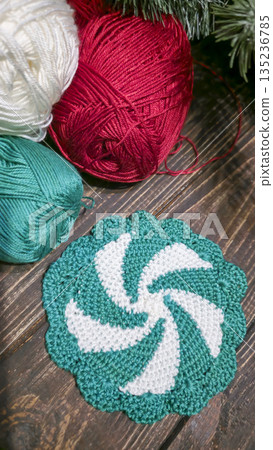 Handcrafted colorful candy-shaped potholders on a wooden background. Food stand. Handcrafted colorful candy-shaped potholders on a wooden background. Food stand. 135236785