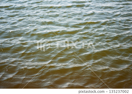 sea water background. blue water texture. calm blue water ripples liquid texture. natural water waves background copy space sea water background. blue water texture. calm blue water ripples liquid texture. natural water waves background copy space 135237002