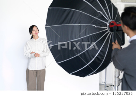 Man adjusting lighting in studio 135237025