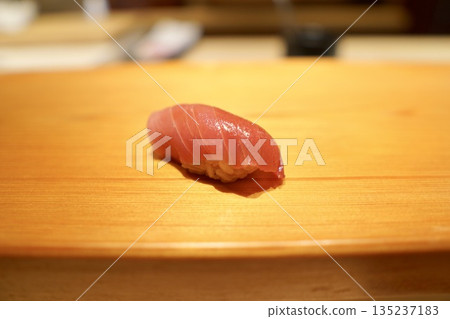 The flower of Edomae sushi: Bluefin tuna (medium fatty tuna) nigiri sushi with boiled soy sauce 135237183