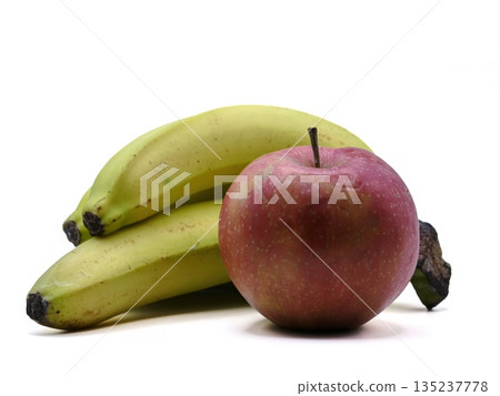 Fresh bananas and red apples set against pure white background emphasizing health and wellness themes 135237778