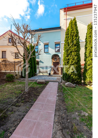Cozy Residential Courtyard with Pathway and Evergreen Trees Cozy Residential Courtyard with Pathway and Evergreen Trees 135237947