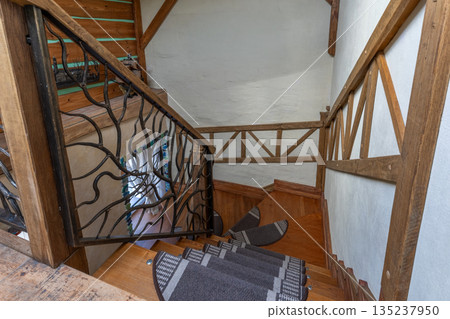 Rustic Wooden Staircase with Wrought Iron Railing Interior Rustic Wooden Staircase with Wrought Iron Railing Interior 135237950