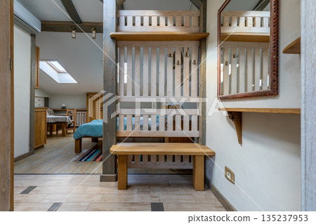 Rustic hallway interior with wooden bench and mirror Rustic hallway interior with wooden bench and mirror 135237953