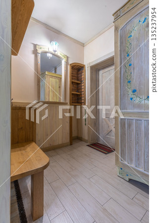 Rustic hallway interior with hand-painted wardrobe and wooden door Rustic hallway interior with hand-painted wardrobe and wooden door 135237954