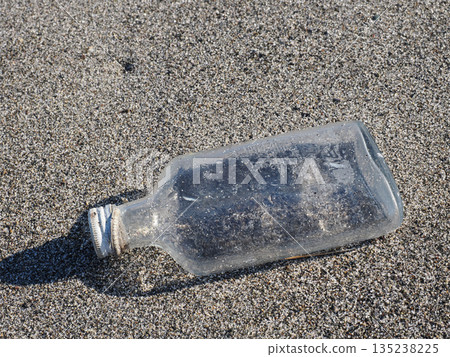 Glass bottle washed up on the beach Glass bottle washed up on the beach 135238225
