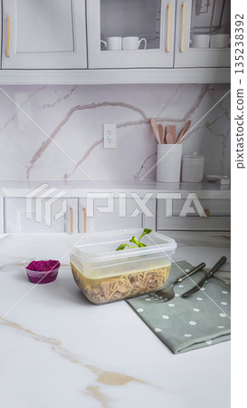 Cold meat jelly. Congealed broth in a transparent bowl. Horseradish next to it. Cold meat jelly. Congealed broth in a transparent bowl. Horseradish next to it. 135238392
