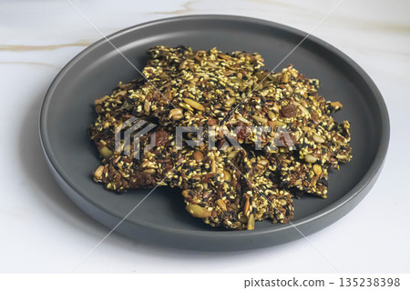 Crispy crackers made from chia, flax, sunflower, and pumpkin seeds, dried 135238398