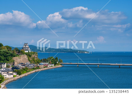 Kitsuki castle on cliff by city and bridge cross turquoise sea, Oita 135238445