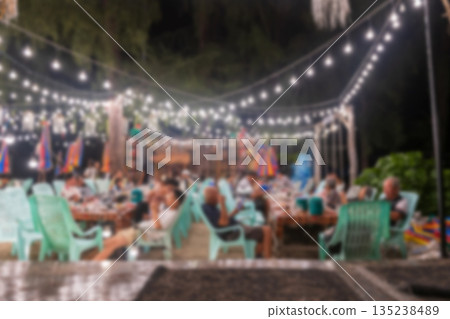 Defocused image of people eating dinner at night, Trang 135238489