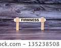 Firmness symbol. A wooden stick secured by Clothespins set over beautiful Realistic Wooden Texture Background. Business and Firmness concept with copy space 135238508