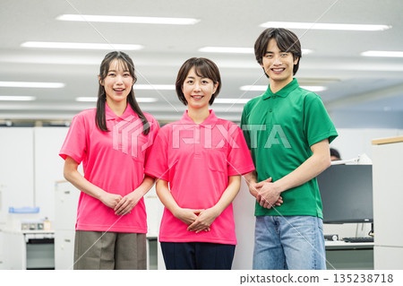 Portrait of a young man and woman working in polo shirts Portrait of a young man and woman working in polo shirts 135238718