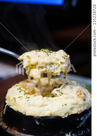 Fluffy Korean steamed egg (Gyeran-jjim) in a hot stone pot, a traditional side dish 135238728