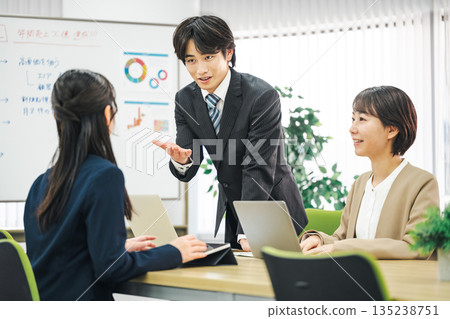 A young businessman giving an impassioned speech at a meeting A young businessman giving an impassioned speech at a meeting 135238751