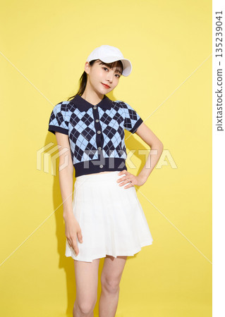 Portrait of a young woman wearing cute sportswear against a light background Portrait of a young woman wearing cute sportswear against a light background 135239041