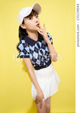 Portrait of a young woman wearing cute sportswear against a light background 135239044