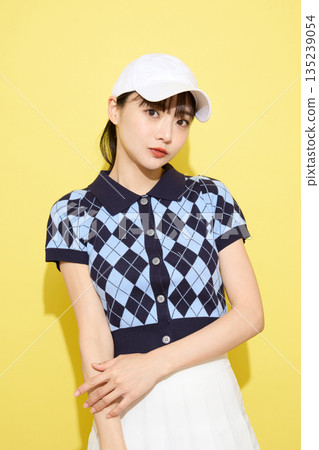 一位年輕女子穿著可愛運動服,背景是淺色的。 一位年輕女子穿著可愛運動服,背景是淺色的。 135239054