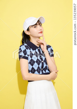 Portrait of a young woman wearing cute sportswear against a light background Portrait of a young woman wearing cute sportswear against a light background 135239057