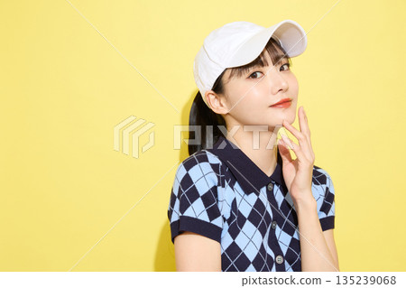 Portrait of a young woman wearing cute sportswear against a light background Portrait of a young woman wearing cute sportswear against a light background 135239068