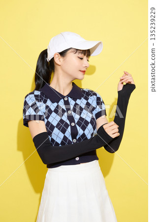 Portrait of a young woman wearing cute sportswear against a light background 135239229