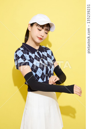 Portrait of a young woman wearing cute sportswear against a light background Portrait of a young woman wearing cute sportswear against a light background 135239231