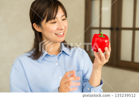Woman holding paprika Woman holding paprika 135239512