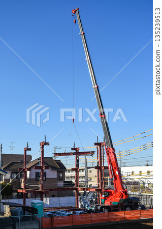 A construction site where steel frames are assembled with a mobile crane A construction site where steel frames are assembled with a mobile crane 135239513