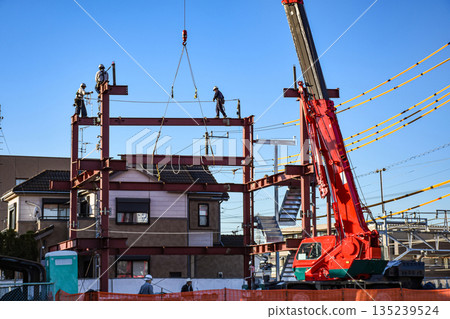 A construction site where steel frames are assembled with a mobile crane A construction site where steel frames are assembled with a mobile crane 135239524