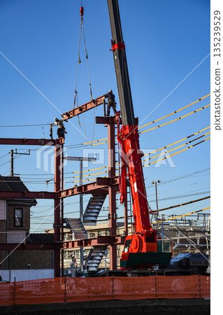 A construction site where steel frames are assembled with a mobile crane A construction site where steel frames are assembled with a mobile crane 135239529